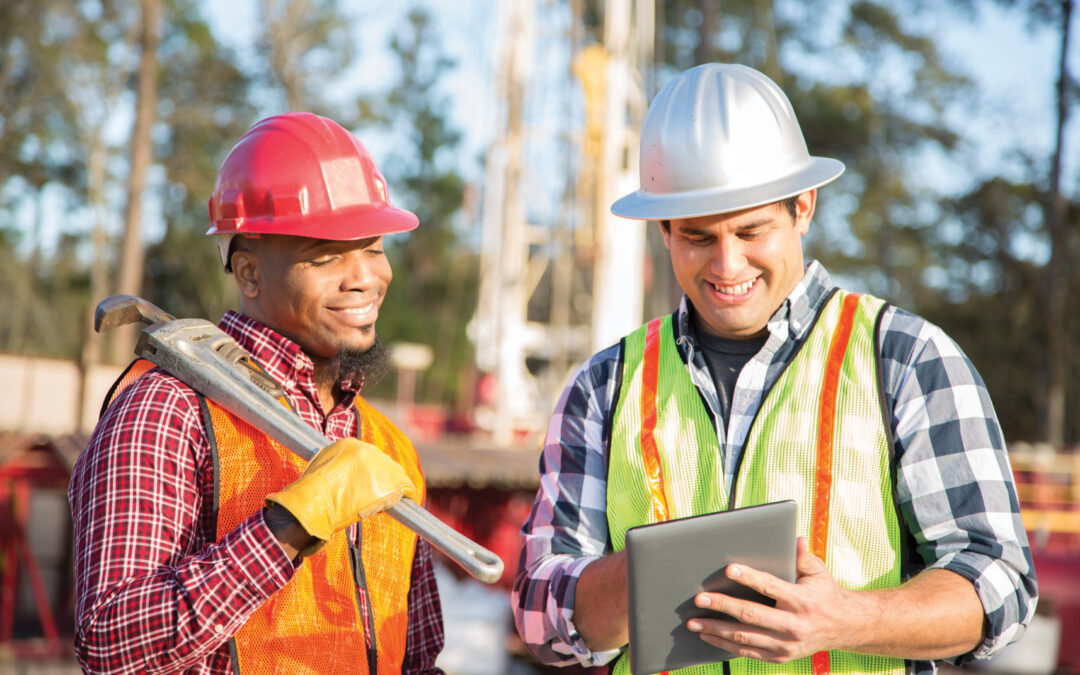 Construction workers at outdoor drilling site.